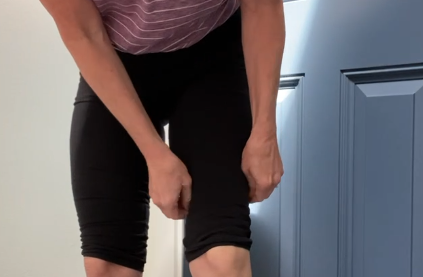 woman yanking on spandex shorts